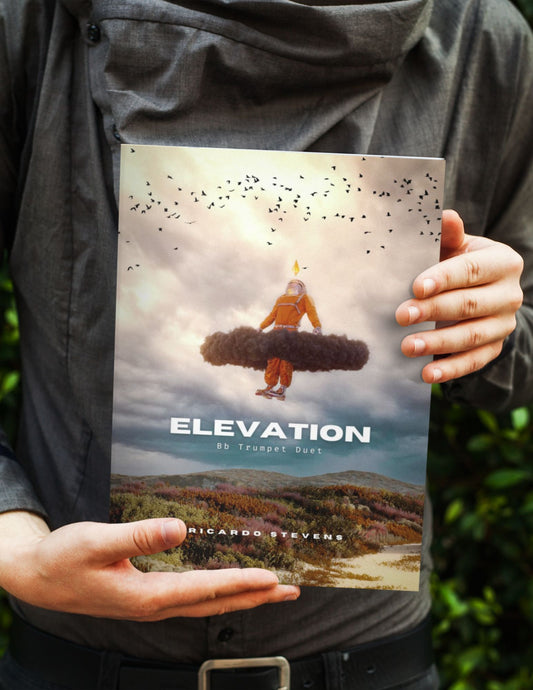 Person holding a book titled 'Elevation' by Ricardo Stevens with a cover illustration of a person on a mountain.