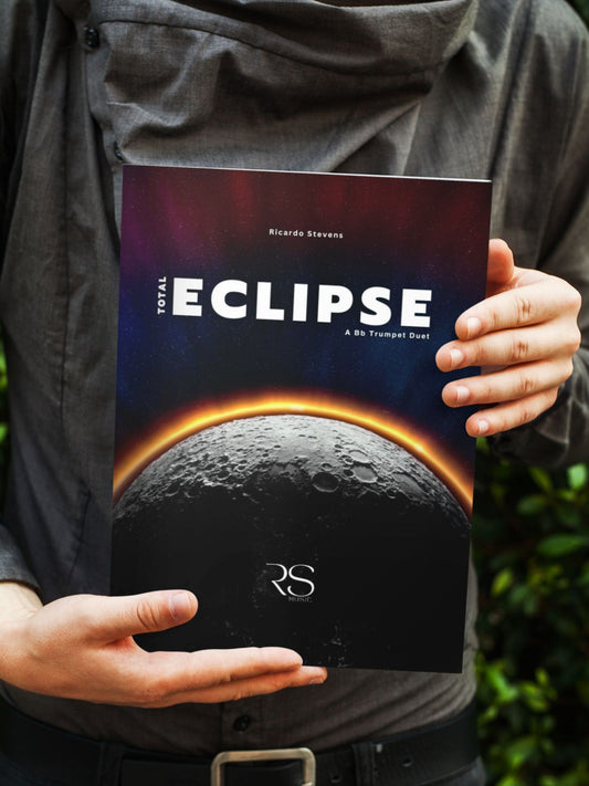 Person holding a book titled 'Eclipse' with a space-themed cover by Ricardo Stevens